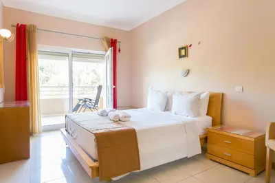 a bedroom with a large bed and a window at Quinta da Barracuda by Golden Zenith in Albufeira