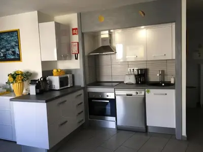 a kitchen with white appliances and white cabinets at Albufeira Portugal Maria appt in Albufeira