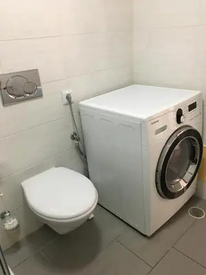 a bathroom with a washing machine and a toilet at Albufeira Portugal Maria appt in Albufeira