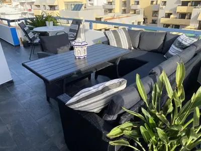 a black couch and a table on a balcony at Albufeira Portugal Maria appt in Albufeira