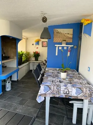 a table in a kitchen with a blue wall at Albufeira Portugal Maria appt in Albufeira