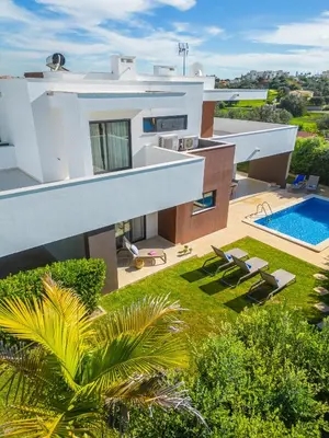 an aerial view of a house with a swimming pool at Villas Novochoro - Large Garden- Heatable Pool by DreamvillasAlbufeira in Albufeira
