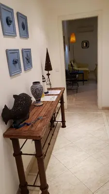 a wooden table with a vase on top of it at Marina Vilamoura Apartment in Vilamoura