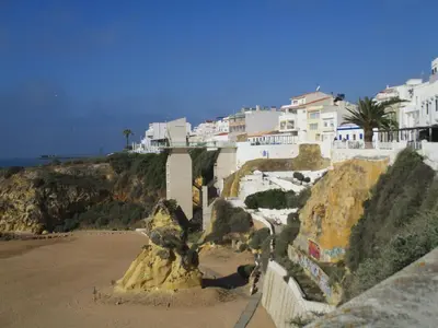 a sand sculpture on a beach next to houses at Bay View Apartment Albufeira in Albufeira
