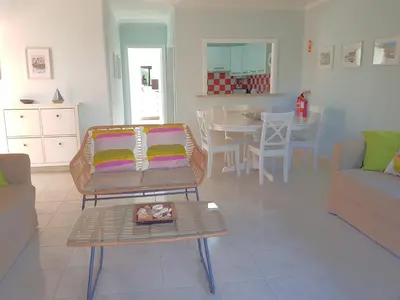 a living room with a couch and a table at Algarve Apartment Falésia in Albufeira