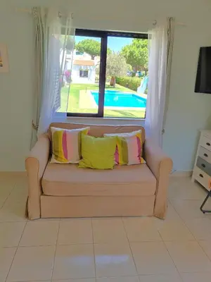 a couch with two pillows on it in a living room at Algarve Apartment Falésia in Albufeira