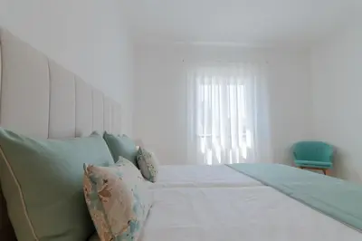 a bedroom with a bed with pillows and a window at Apartments Salomé in Albufeira