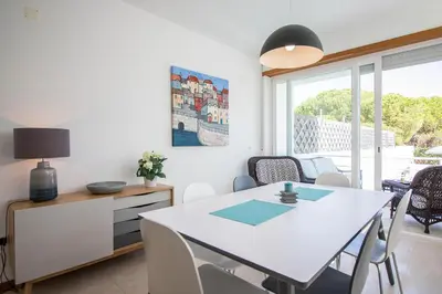 a dining room with a white table and chairs at Villa Granada in Almancil