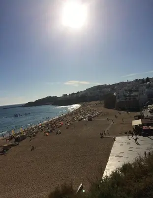 a beach with a lot of people and the ocean at Bellavista Ténis Clube - Studio Sea View in Albufeira