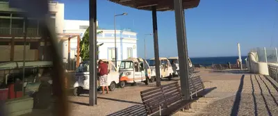a row of parked cars parked next to a building at Bellavista Ténis Clube - Studio Sea View in Albufeira