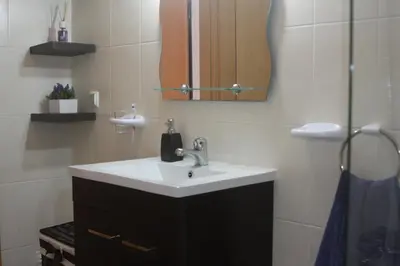 a bathroom with a sink and a mirror at Albufeira Lovely new Apartment W/ Pool in Albufeira