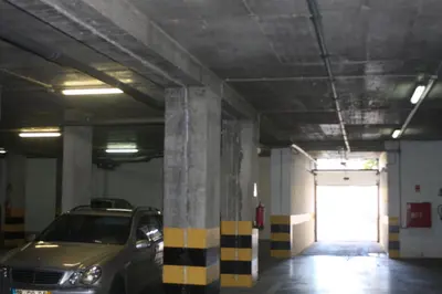 a parking garage with a car parked in it at Albufeira Lovely new Apartment W/ Pool in Albufeira
