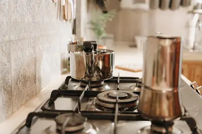 a stove with pots and pans on top of it at Casa da Madalena Backpackers Hostel in Faro
