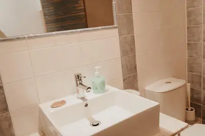 a bathroom with a sink and a toilet at Casa da Madalena Backpackers Hostel in Faro