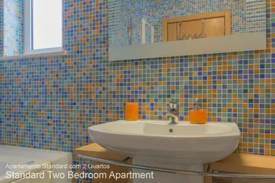 a bathroom with a sink and a mirror at Akisol Vilamoura Nature in Vilamoura