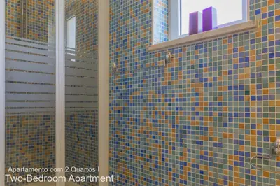 a bathroom with blue and yellow tiles on the wall at Akisol Vilamoura Nature in Vilamoura