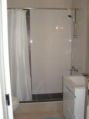 a bathroom with a shower and a toilet and a sink at 180° Sea View - Fabulosa vista mar! in Quarteira