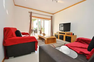 a living room with a couch and a tv at Townhouse Mar 1 by Algarve Vacation in Albufeira