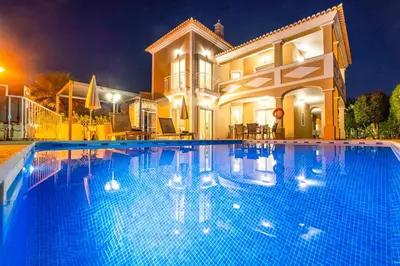 a large swimming pool in front of a house at Villa Florença by Algarve Vacation in Albufeira