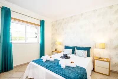 a bedroom with a bed with towels on it at Villa Alegria by Algarve Vacation in Albufeira