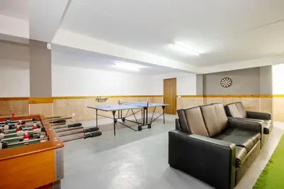 a room with a ping pong table and a leather couch at Villa Alegria by Algarve Vacation in Albufeira
