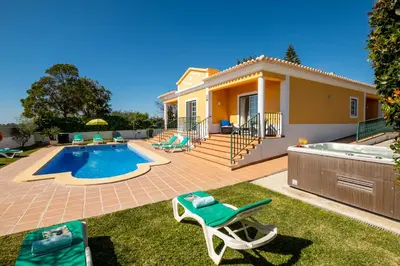 a villa with a swimming pool and a house at Villa Alegria by Algarve Vacation in Albufeira