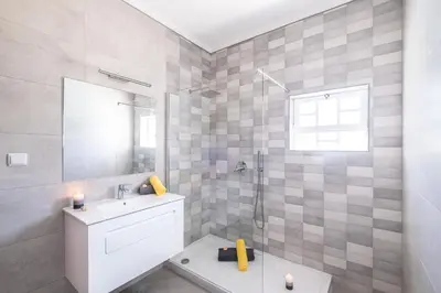 a bathroom with a shower and a toilet and a sink at Villa Valentina by Algarve Vacation in Almancil