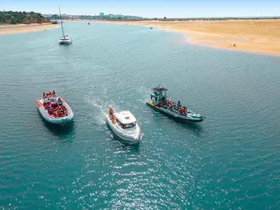 three boats in a body of water next to a beach at Villa Sardenha by Algarve Vacation in Guia