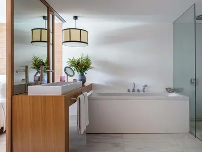 a bathroom with a large white tub and a sink at Victoria Golf Resort and Spa Managed by Accor in Vilamoura