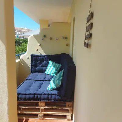 a blue couch sitting on top of a stairs at Olhos do Mar in Albufeira