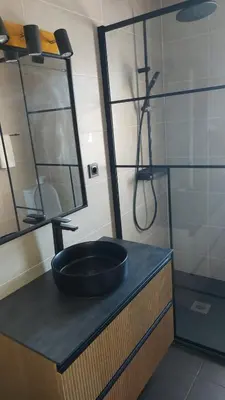 a bathroom with a black sink and a shower at Olhos do Mar in Albufeira