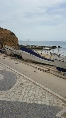 a group of boats sitting on a beach at Olhos do Mar in Albufeira