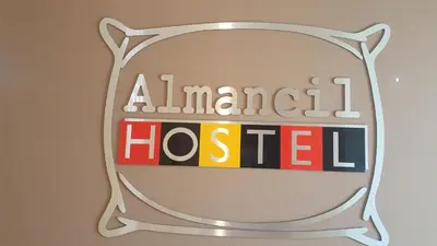 a sign for an american hosled on a wall at Almancil Hostel in Almancil