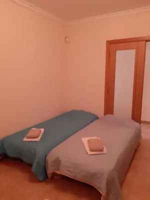 two twin beds in a room with pink walls at Edifice Ibérico in Albufeira