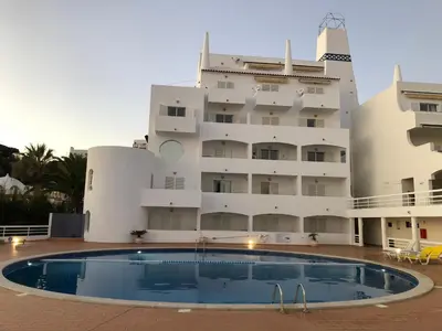 a building with a swimming pool in front of a building at Borda d`Água, Praia da Oura in Albufeira