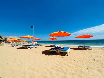 a beach with chairs and umbrellas and the ocean at Borda d`Água, Praia da Oura in Albufeira