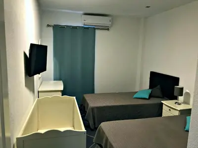 a small room with two beds and a television at Borda d`Água, Praia da Oura in Albufeira