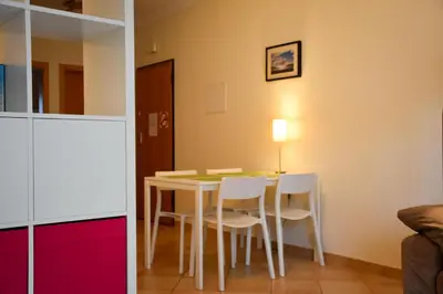 a dining room with a table and white chairs at Old Village Prestige 101 in Vilamoura