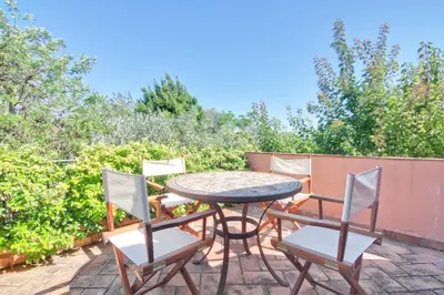 a patio with a table and four chairs at Casinha Antiga in Boliqueime