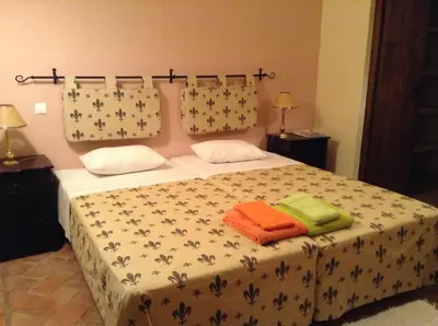 a bedroom with a bed with towels on it at Casinha Antiga in Boliqueime