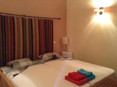 a bed with two towels on it in a room at Casinha Antiga in Boliqueime
