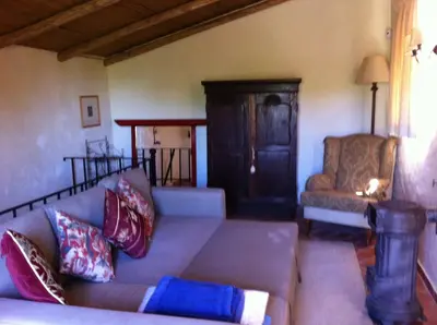 a living room with a couch and a chair at Casinha Antiga in Boliqueime