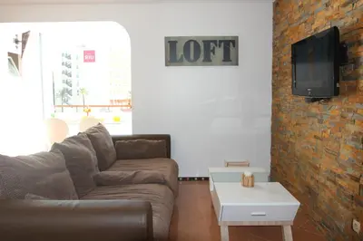 a living room with a couch and a tv at Beach Center 2 - 300m beach in Albufeira