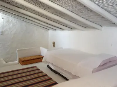 a white bedroom with two beds and a window at Casa da Esperança – Rural and beach Villa in Algarve in Boliqueime