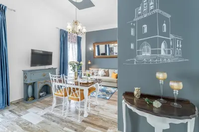a dining room and living room with a dining table and a room with a fireplace at Main Street Apartments by Raspberry Cascade in Faro
