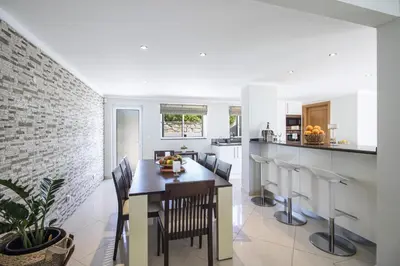 a kitchen and dining room with a table and chairs at Villa Vista in Valados