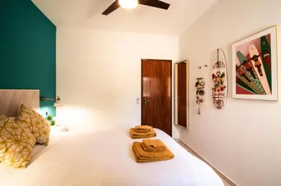 a bedroom with a bed with two towels on it at Quinta do Paraíso - Bed&Shower in Albufeira