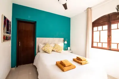 a bedroom with a white bed with two towels on it at Quinta do Paraíso - Bed&Shower in Albufeira