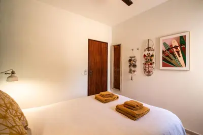 a bedroom with a bed with two towels on it at Quinta do Paraíso - Bed&Shower in Albufeira