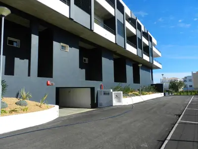 an empty parking lot in front of a building at Casa Sensa in Albufeira